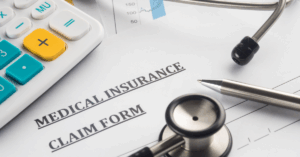 Close up of medical insurance claim form with stethoscope and calculator