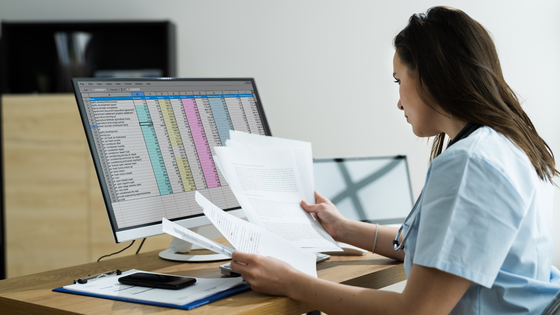 Medical coder at desk with desktop showing coding and charge entry