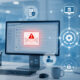 Phishing email alert on a healthcare billing workstation with connected revenue cycle workflow icons.